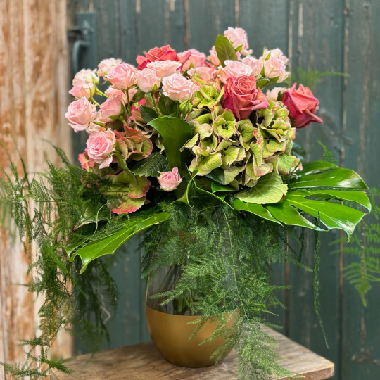 Pink bouquet in vase of hydrangea and pink spray roses